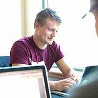 An SPU student works on their laptop